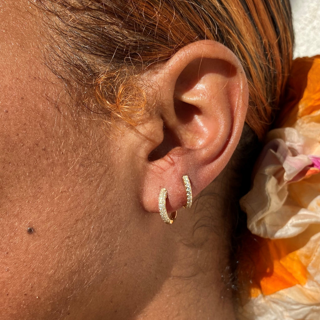 Diamond pave huggies earrings.